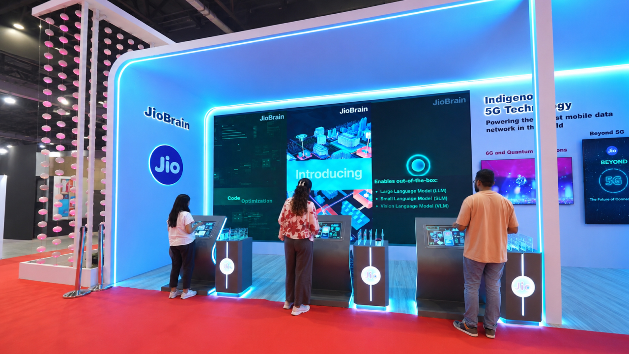 Visitors interact with JioBrain 5G technology displays at an exhibition booth